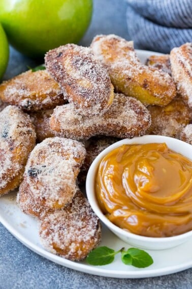 A platter of cinnamon sugar coated apple fries served with caramel dip.