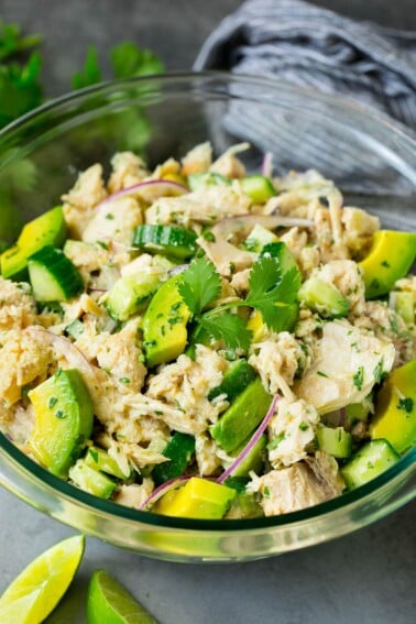 A serving bowl of avocado tuna salad topped with cilantro.