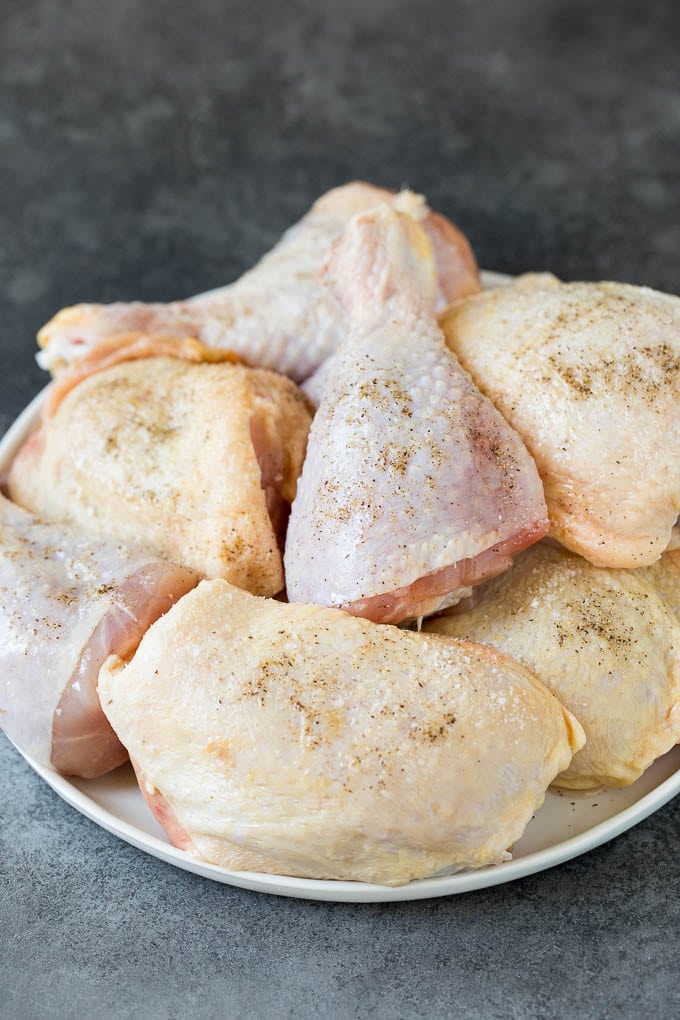 Raw chicken pieces on a plate.