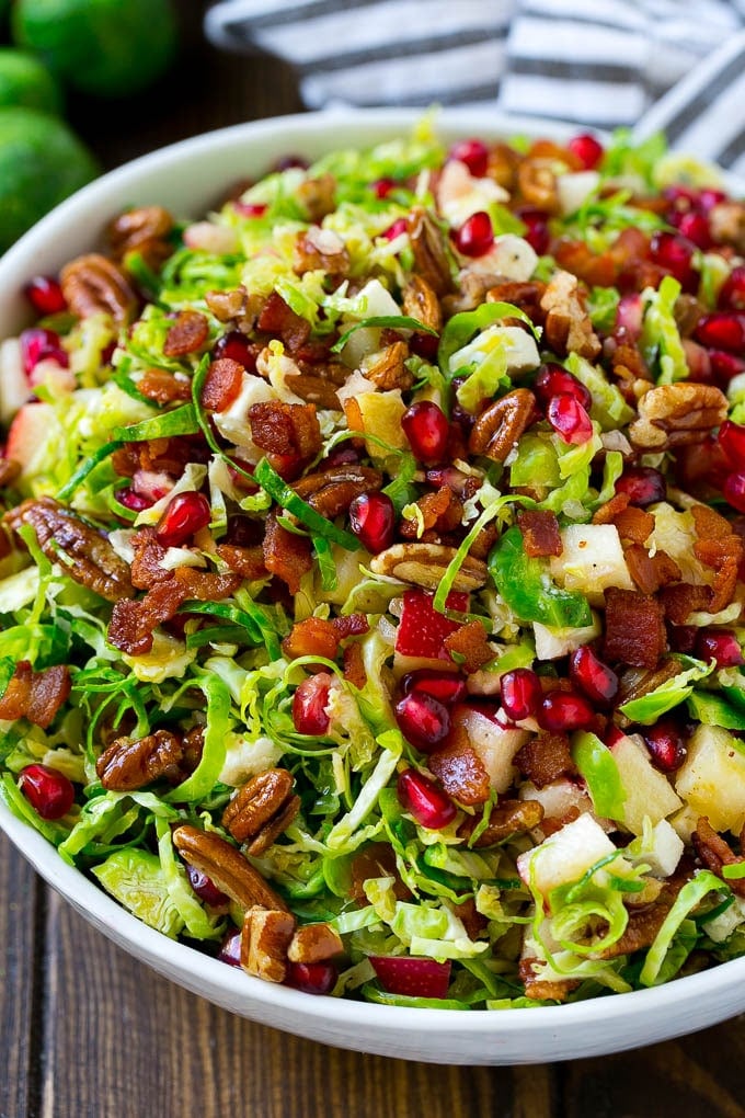 Brussels sprout salad with shredded brussels sprouts, pomegranate, pecans, feta cheese, apples and bacon.