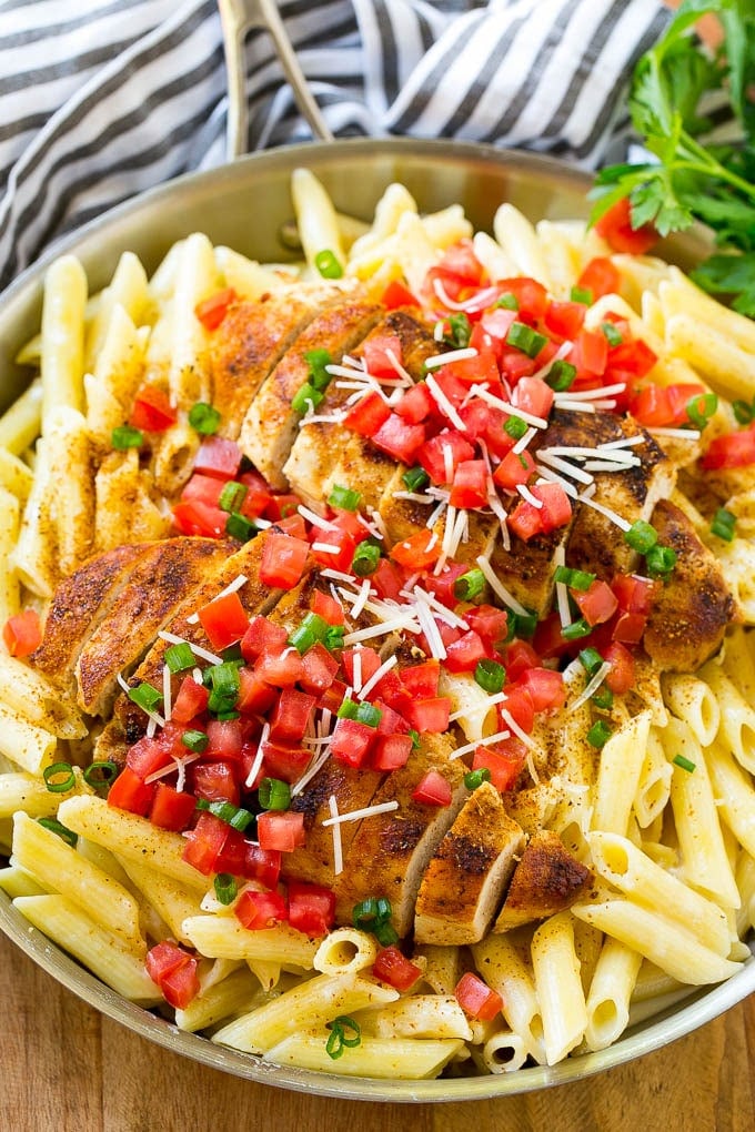 A pan of Cajun chicken pasta with creamy penne and grilled chicken.