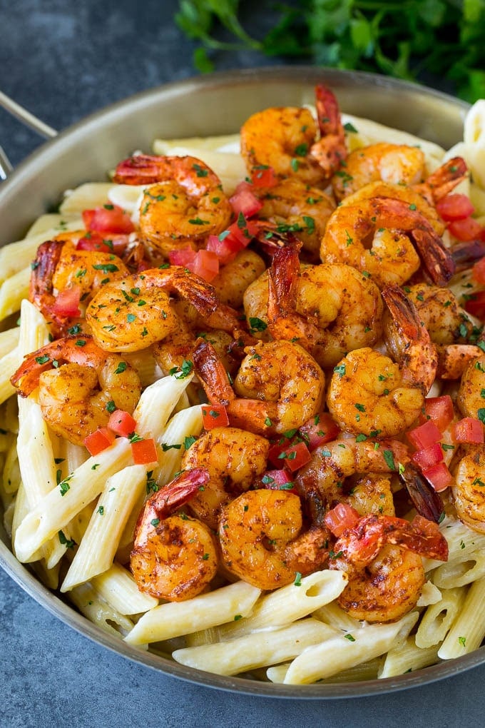 Cajun shrimp pasta with spiced shrimp, creamy sauce and tomatoes.