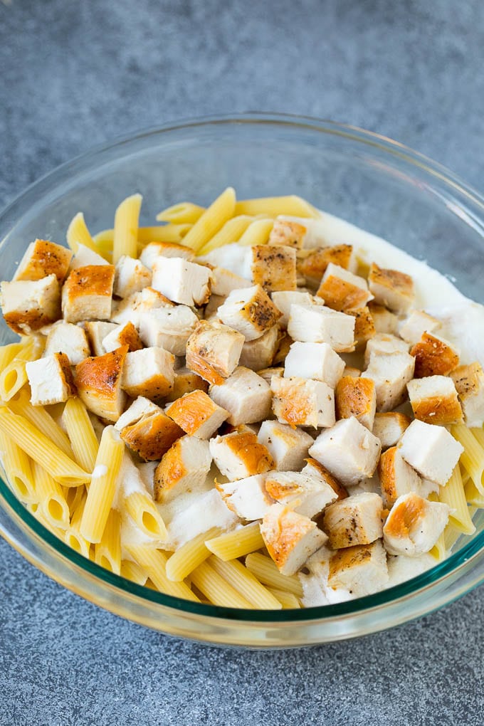 Chicken, pasta and creamy sauce in a bowl.