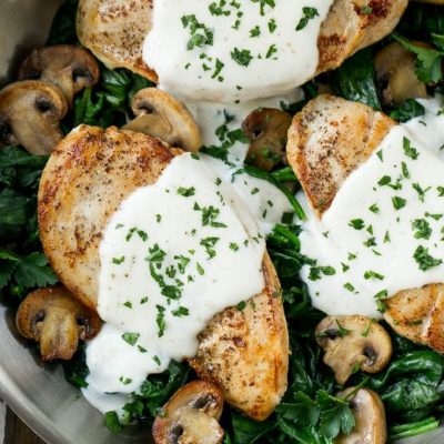 This recipe for chicken florentine is golden brown chicken breasts, topped with a creamy sauce and served over a bed of spinach. A classic dinner that will have you licking your plate!