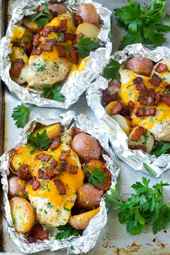 Chicken foil packets with potatoes, bacon and parsley.