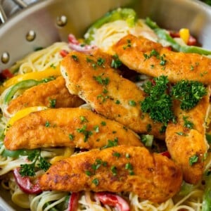 Chicken scampi with breaded chicken tenders served over creamy pasta and peppers.