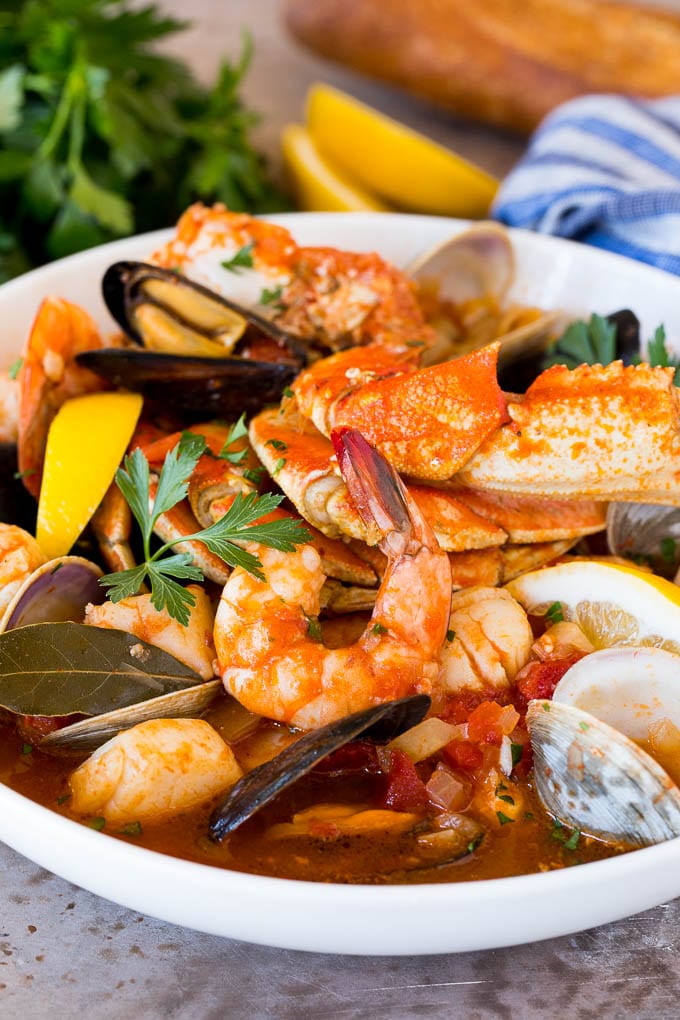 A large bowl of cioppino with crab, shrimp and shellfish.