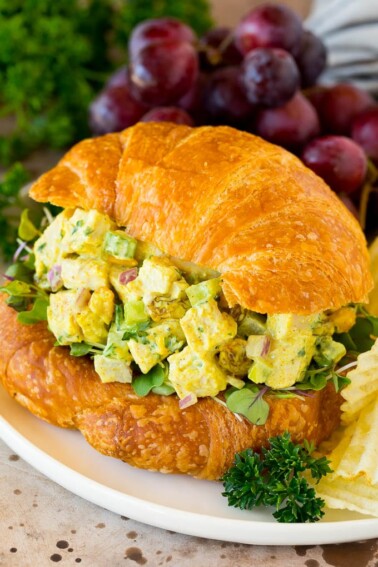 Curry chicken salad served on a croissant.