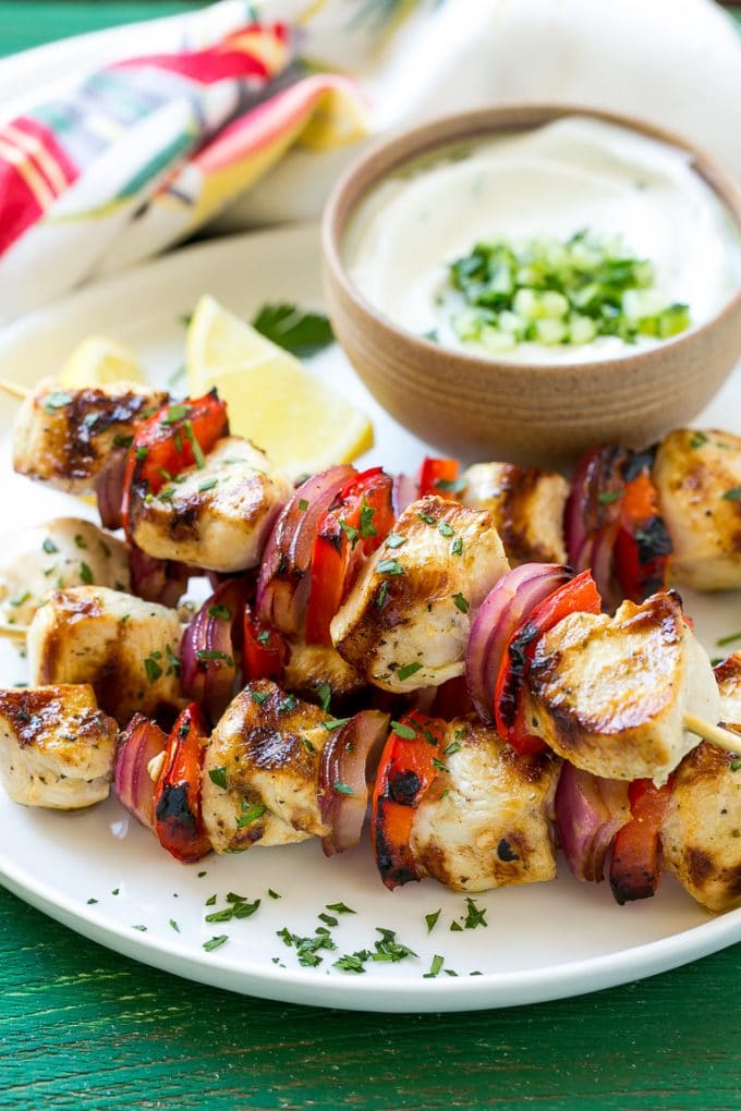 This recipe for Greek chicken kabobs is garlic and herb marinated chicken and colorful vegetables, skewered and grilled to perfection. Serve these skewers with a creamy cucumber yogurt dip for an easy and delicious dinner!