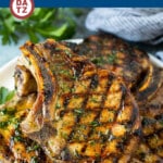 A plate of grilled pork chops which are soaked in a flavorful marinade, then cooked to golden brown perfection.