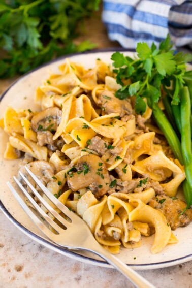 A plate of ground beef stroganoff served with green beans.