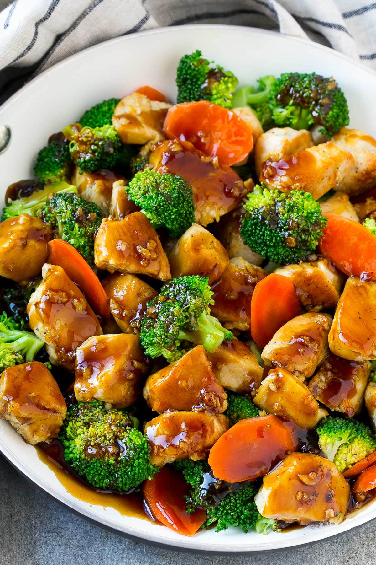 A pan of honey garlic chicken stir fry with broccoli and carrots.