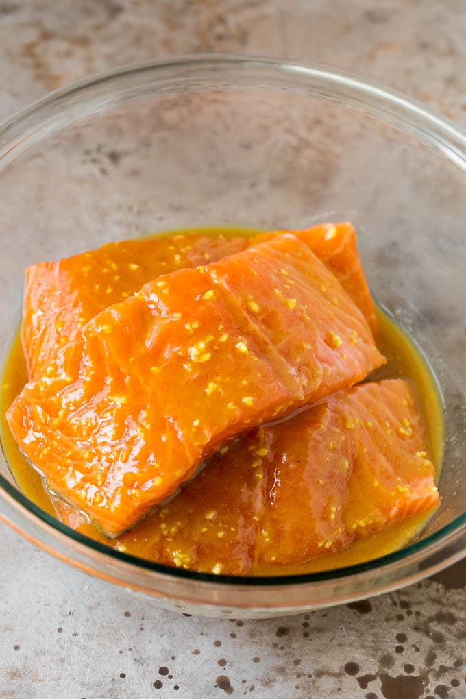 Salmon in a bowl of marinade.