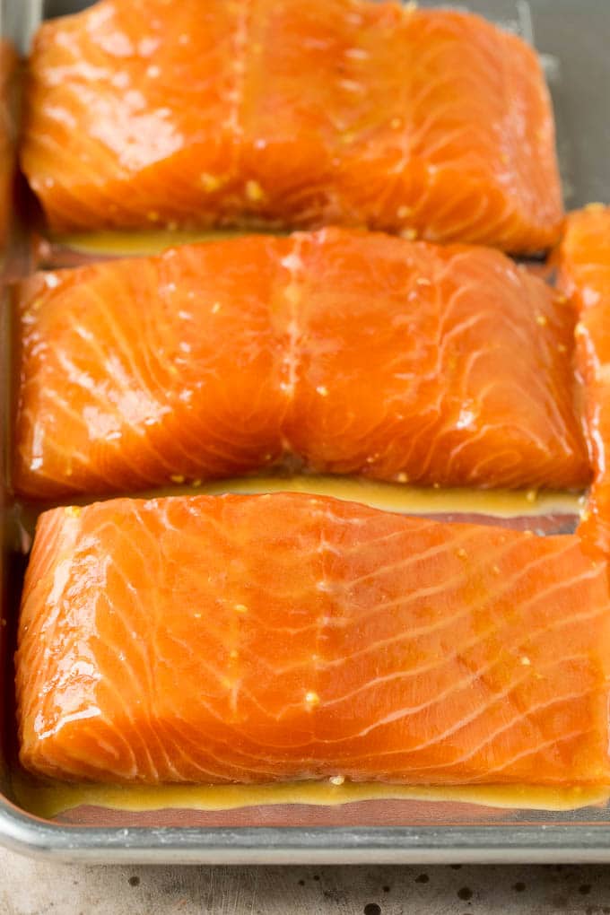 Marinated salmon pieces on a sheet pan.