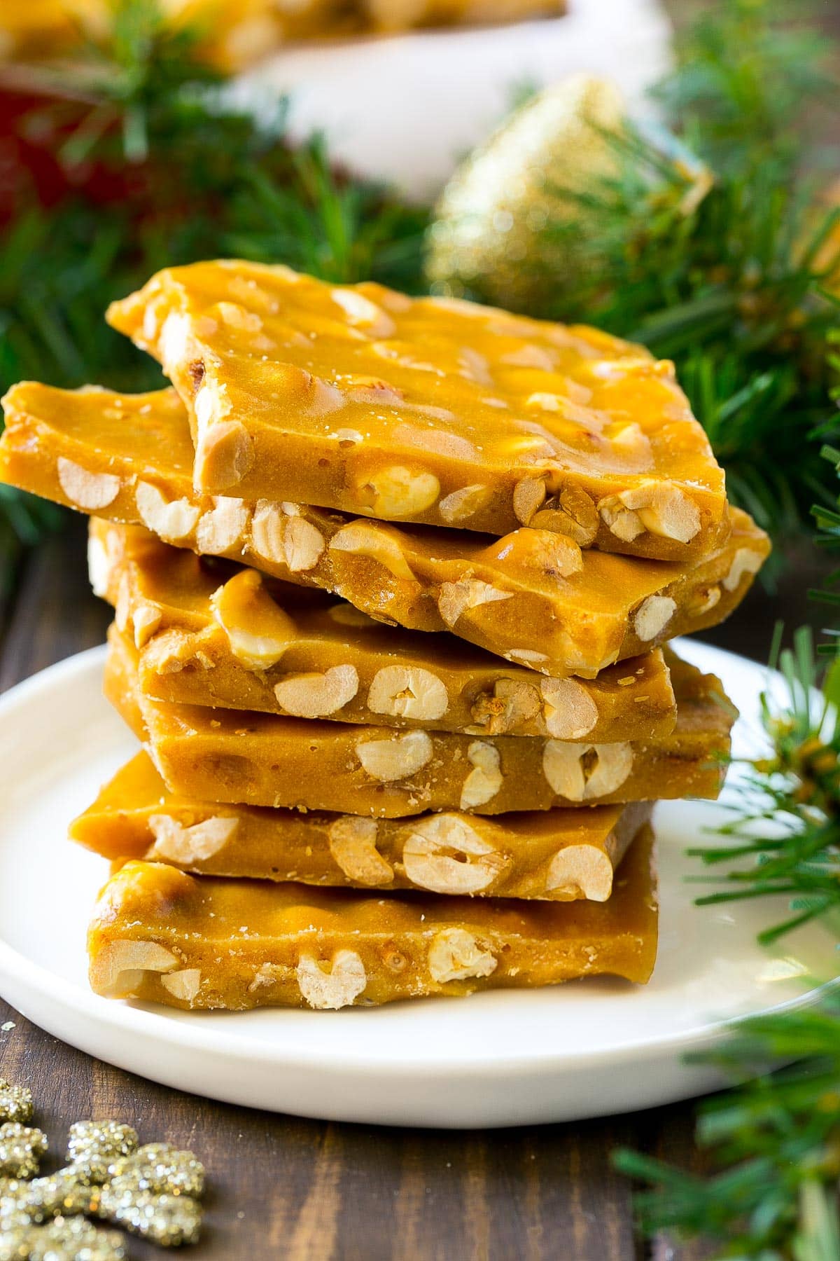 Peanut brittle stacked onto a serving plate.