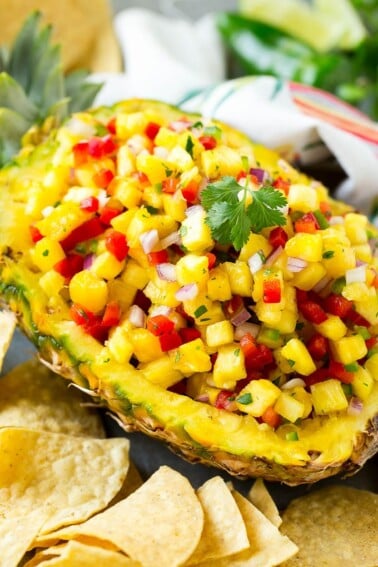 A pineapple boat filled with pineapple salsa.