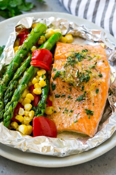 A salmon foil packet that can be baked or grilled with seasoned salmon and fresh vegetables.