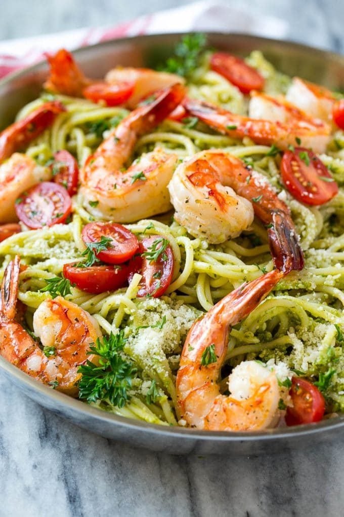 Pesto pasta with seared shrimp, cherry tomatoes and parmesan cheese.