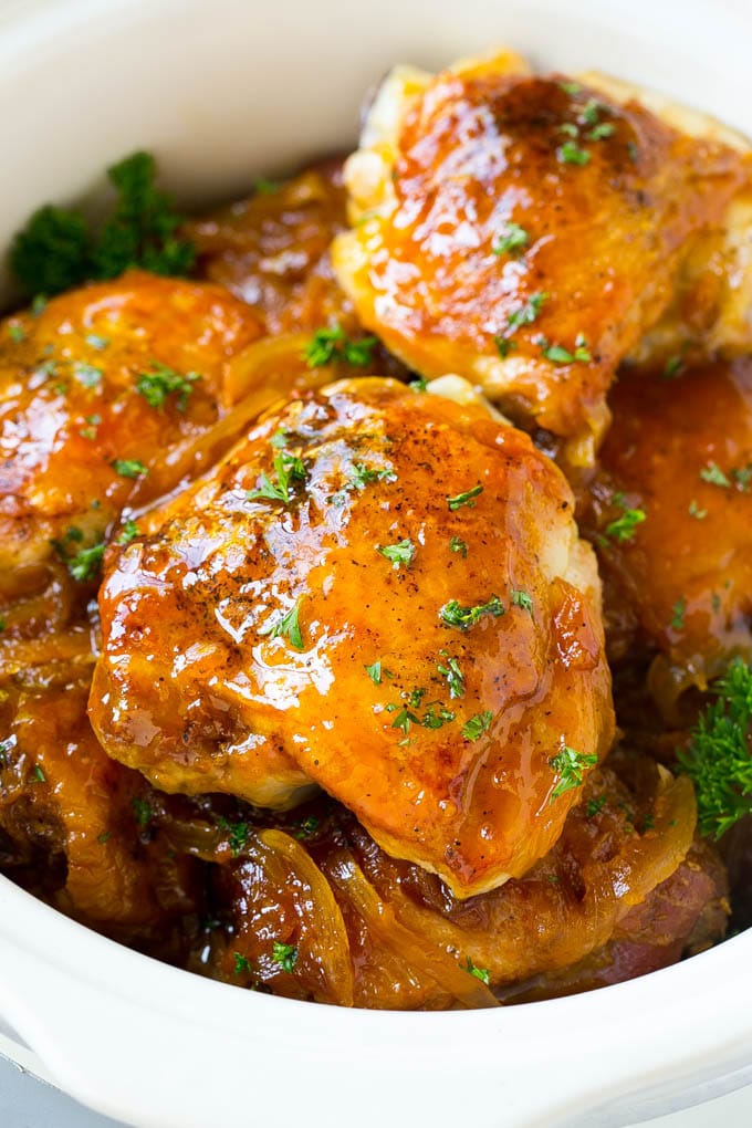 A close up of slow cooker apricot chicken topped with parsley.