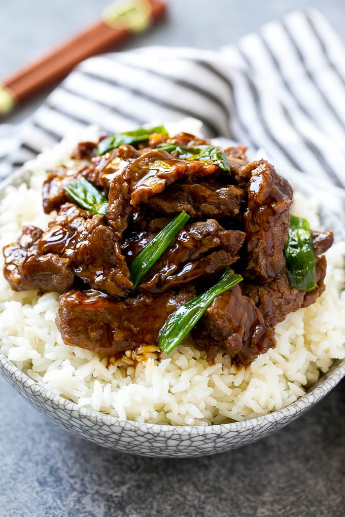 A bowl of rice topped with slow cooker mongolian beef.