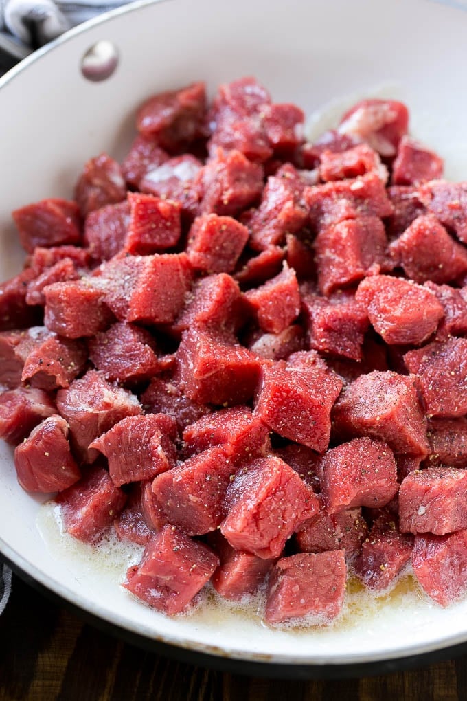 Cubes of raw steak to be cooked in garlic butter.